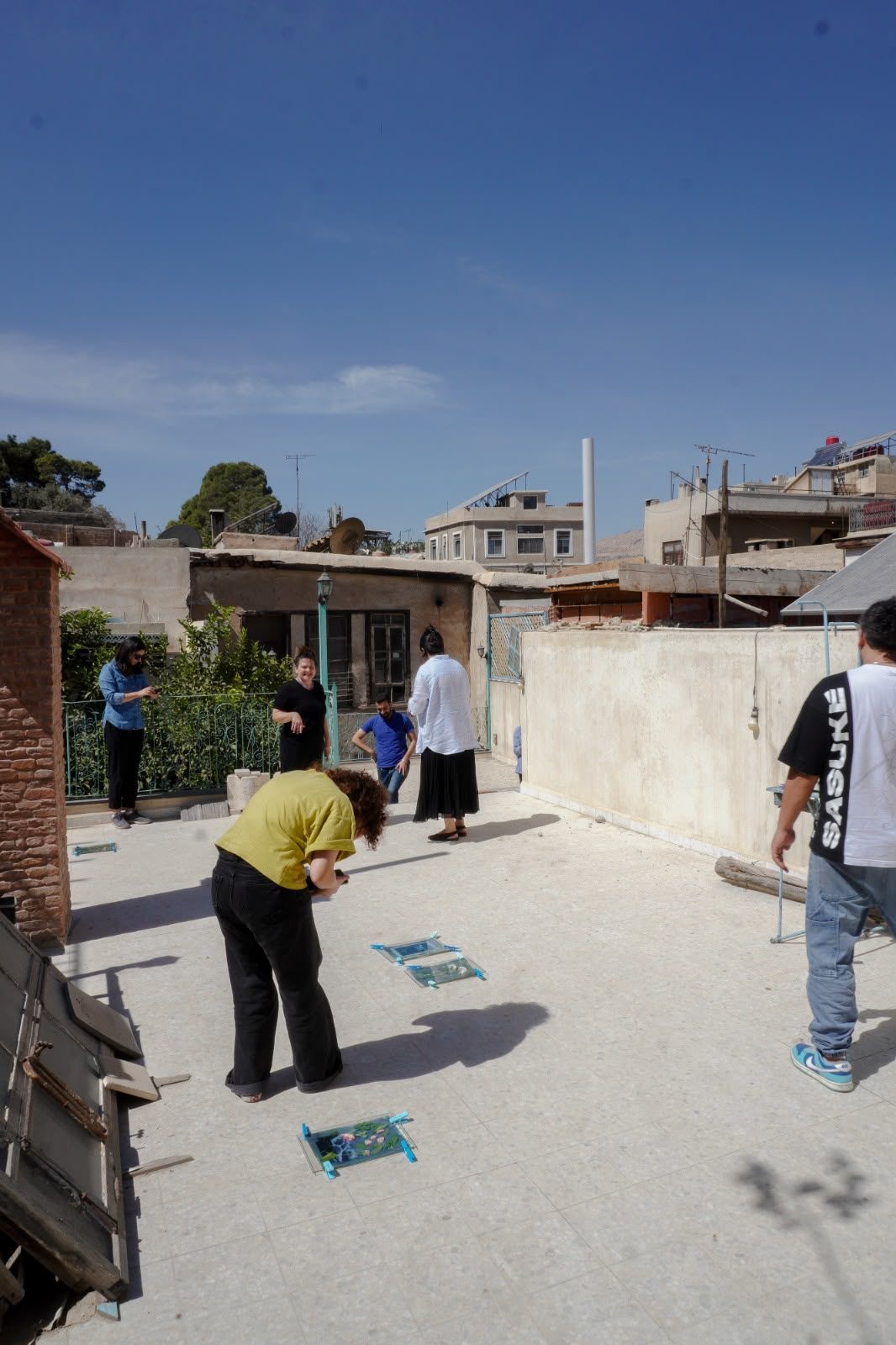 Participants coating paper at the cyanotype workshop table, Damascus, September 2026